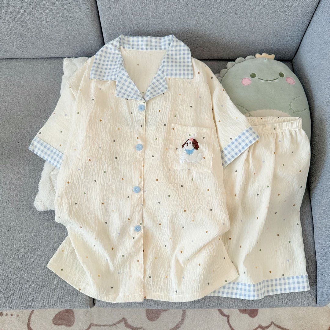 Women's bubble gauze short‑sleeve & shorts pajama set, lapel collar with blue‑white gingham trim, cream‑colored main fabric scattered with colorful polka dots, cartoon dog embroidery on chest pocket, light‑blue buttons, loose & lightweight.