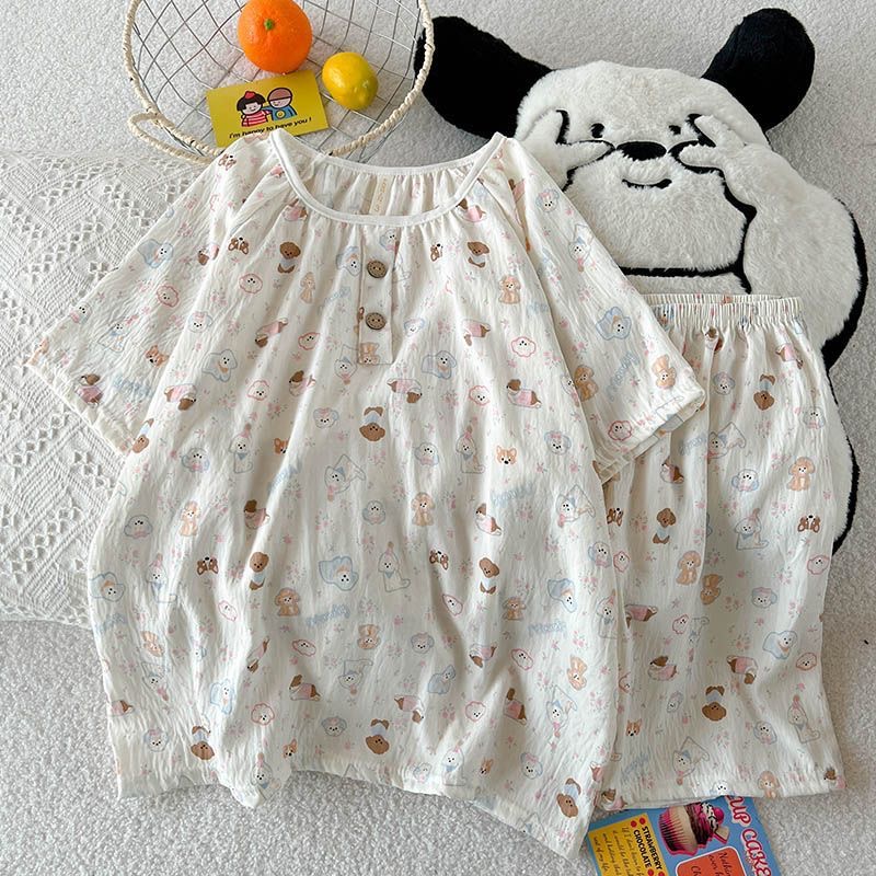 Women’s cartoon puppy‑print two‑piece pajama set, crafted from crinkled lightweight fabric. Short‑sleeve top features elastic round neck with partial button placket, covered with multicolored cute puppy patterns. Matched elastic‑waist shorts, loose‑fit silhouette, soft and lovely daily home loungewear.
