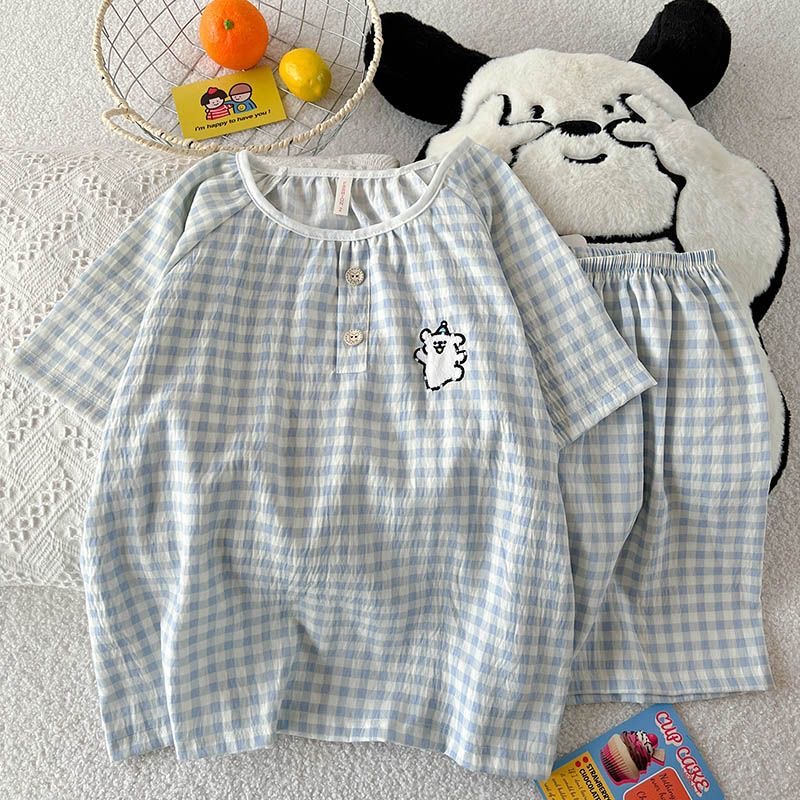 Women’s blue‑white gingham two‑piece pajama set, crafted from crinkled lightweight fabric. Short‑sleeve top features elastic round neck with partial button placket and cute cartoon bear embroidery on the chest. Matching elastic‑waist shorts, loose relaxed silhouette, fresh minimalist home loungewear.